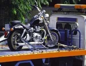 a motorcycle towed safely in a tow truck