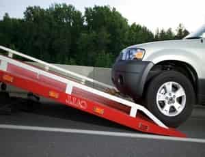 a car getting a help to be towed away for flat rate towing service