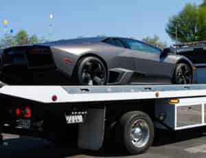 a flatbed service tow truck for sport and sport cars with lamborghini on top