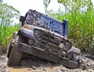 a four wheeler car stuck in mud and needs a wrecker service